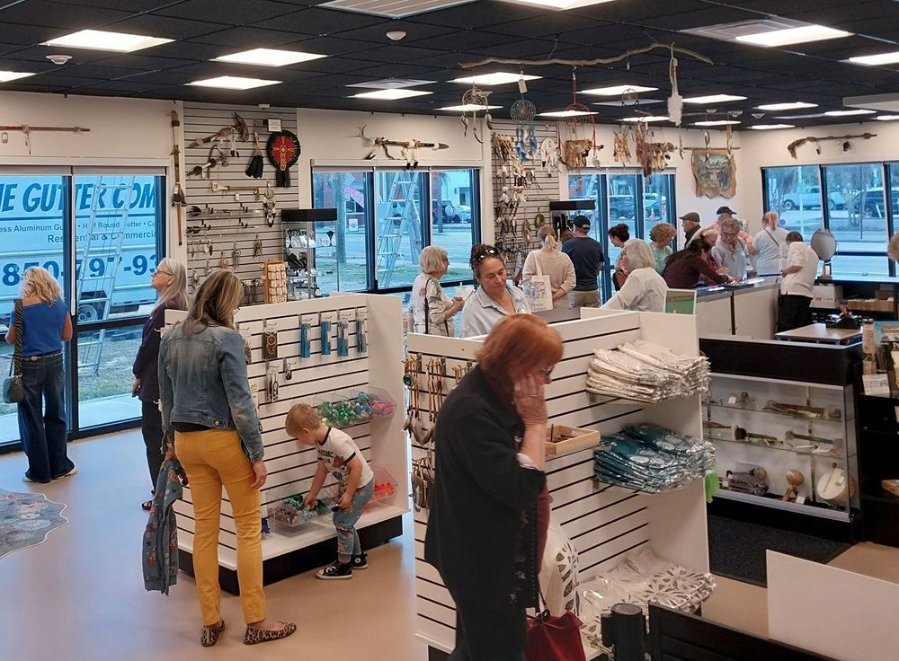 A view of the new museum store, showing merchandise displays and people shopping